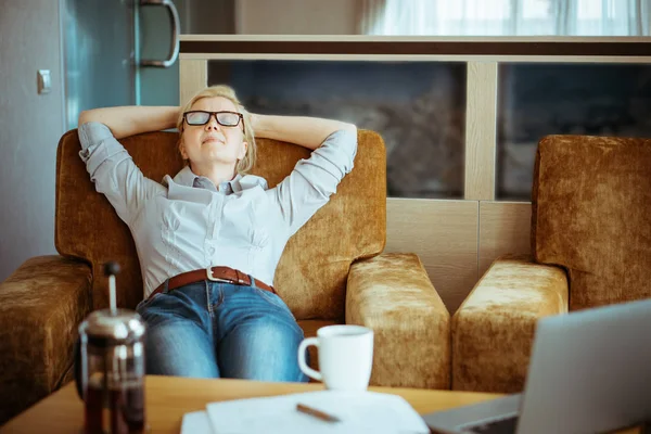 Woman in casual clothes resting at home.