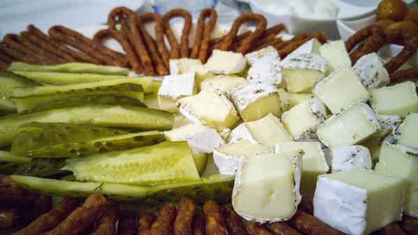 Plate with pickles, hermelin cheese and kabanos - sausage sticks — Stock Photo, Image