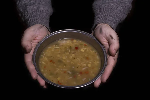 Con in mano una ciotola di zuppa. Concetto di povertà — Foto Stock