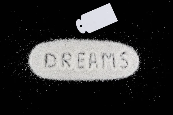 Azúcar blanco con la palabra sueños. Dulces sueños concepto . — Foto de Stock