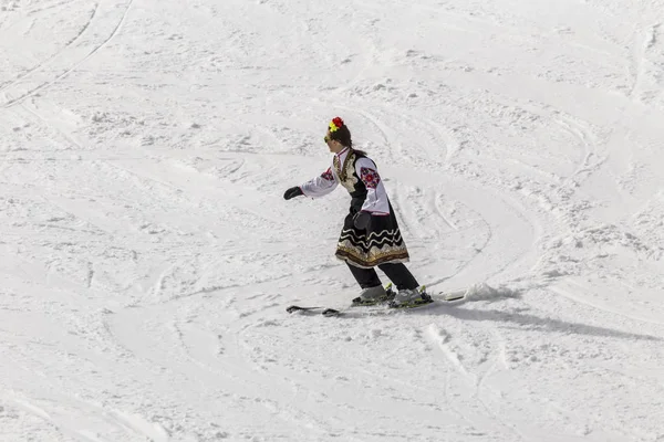 Personer som skidåkning klädd med traditionella bulgariska kläder. — Stockfoto