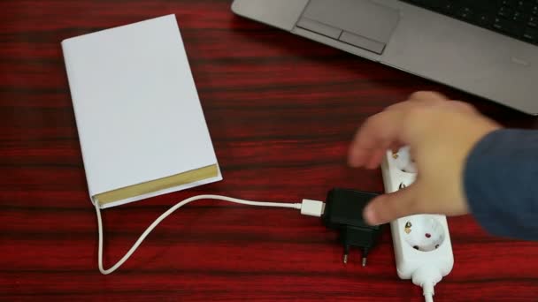 Book charging on a desk video — Stock Video