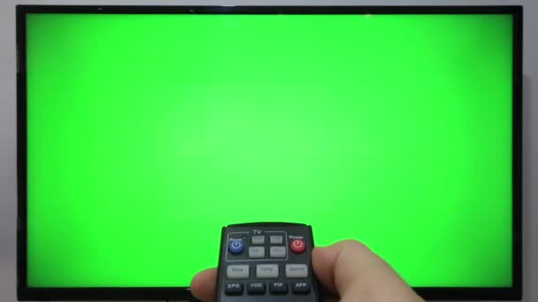 Persona Apuntando Televisor Remoto Pulsando Botones Delante Televisor Con Pantalla — Vídeo de stock