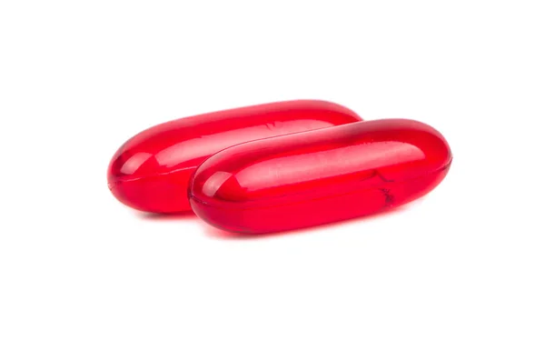 Duas cápsulas de comprimidos vermelhos — Fotografia de Stock