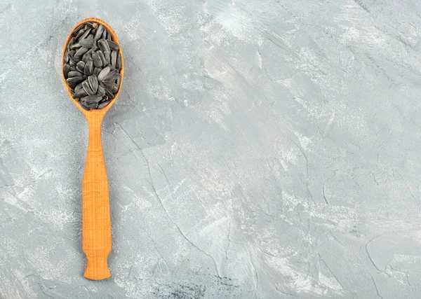 Sunflower seeds in a spoon — Stock Photo, Image