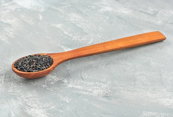 Black sesame in spoon — Stock Photo, Image