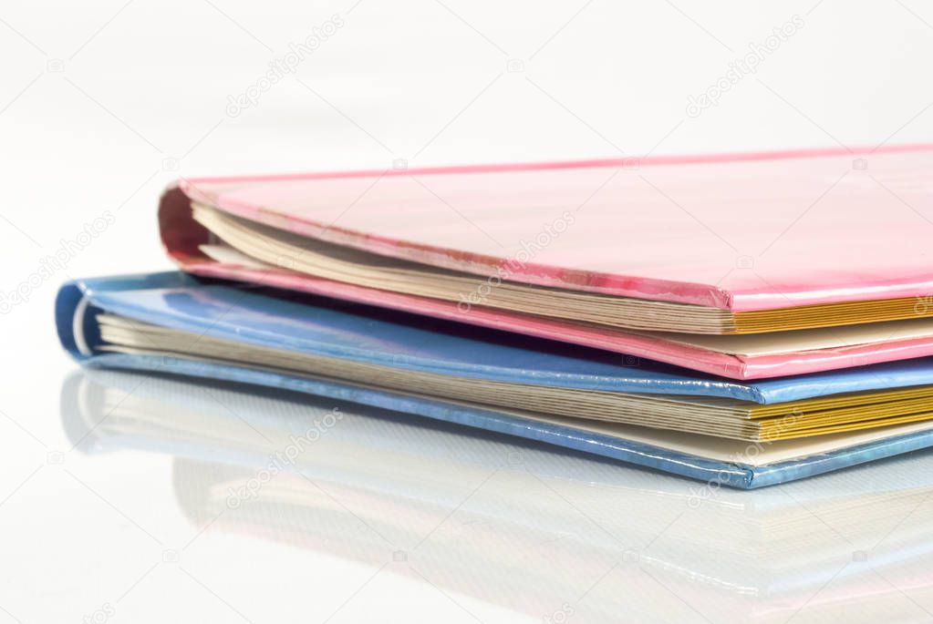 Closed photo albums on the table with reflection