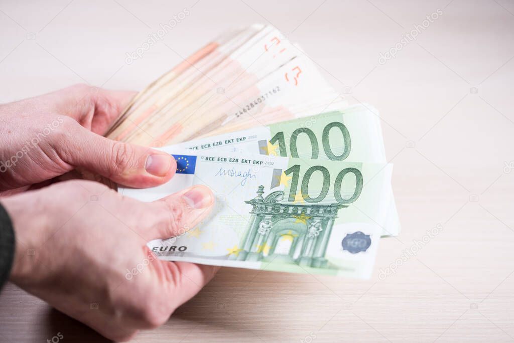 Man holding paper money - euros in the hand