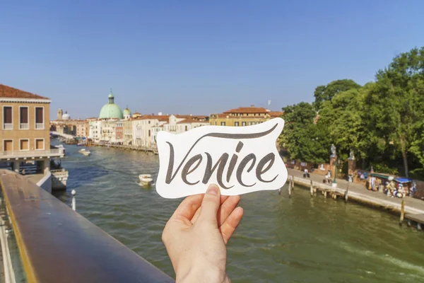 Venice modern lettering in a hand over Grand canal.