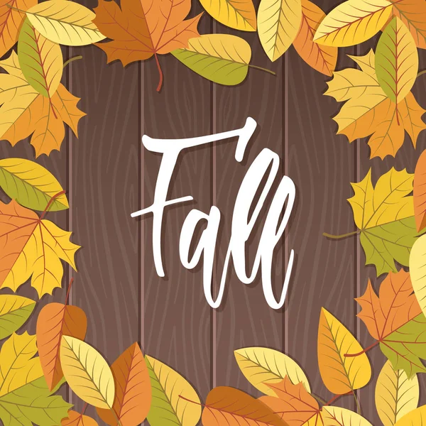 Fall modern calligraphy and falling leaves on wooden background — Stock Photo, Image