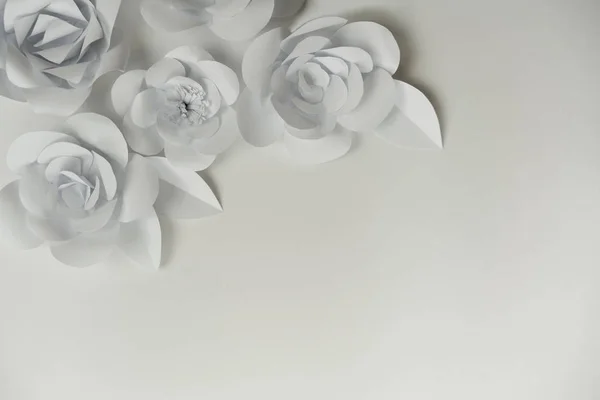 stock image Minimalist monochromatic white paper flowers with copy space on right bottom corner. Hand crafted flowers closeup photo.