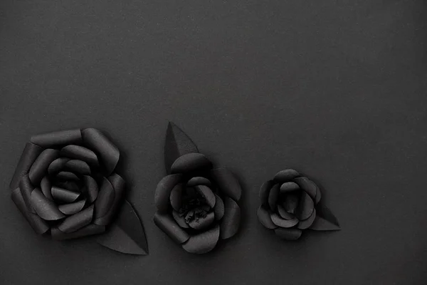 Minimalist black paper flowers and copy space for your text on upper part.