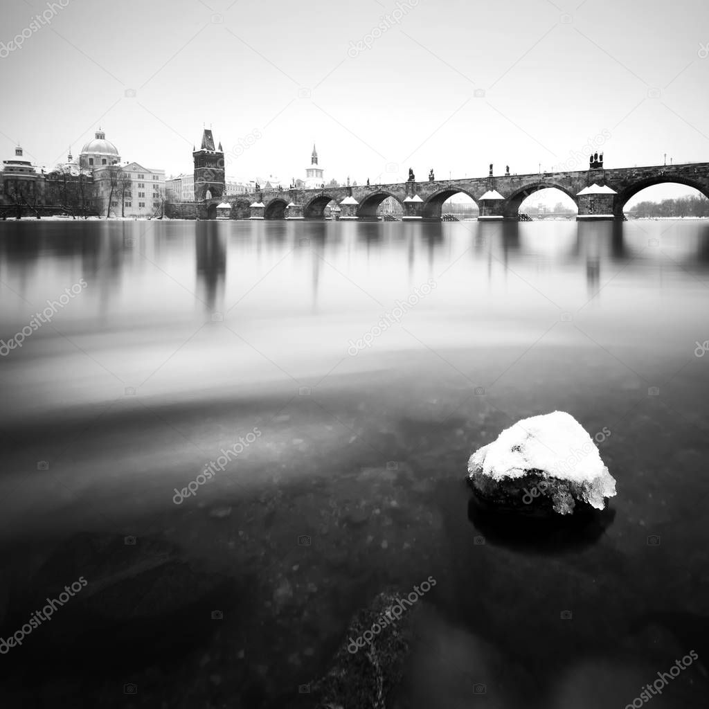 Majestic Charles Bridge during winter day with ice and snow, Prague, Czech republic