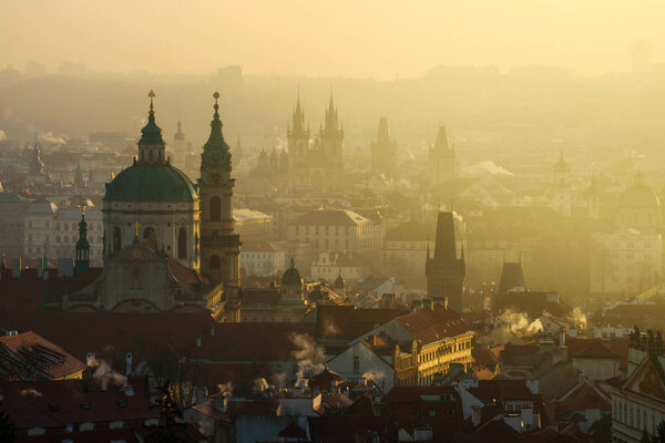 Amazing Prague foggy sunrise with St. Nicolas church, Czech republic
