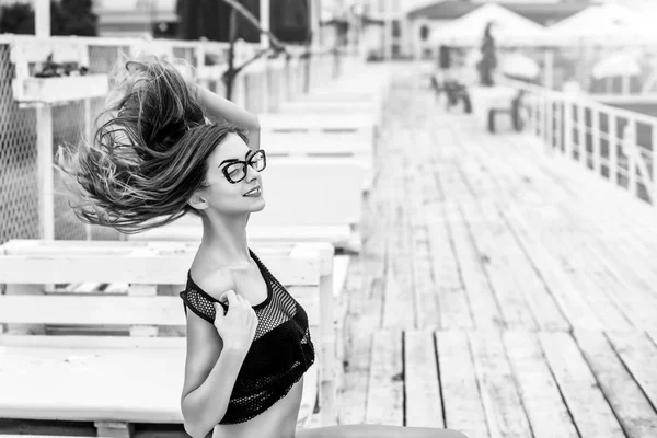 Brunette girl in black swimsuit relaxing outdoorBrunette girl in — Stock Photo, Image