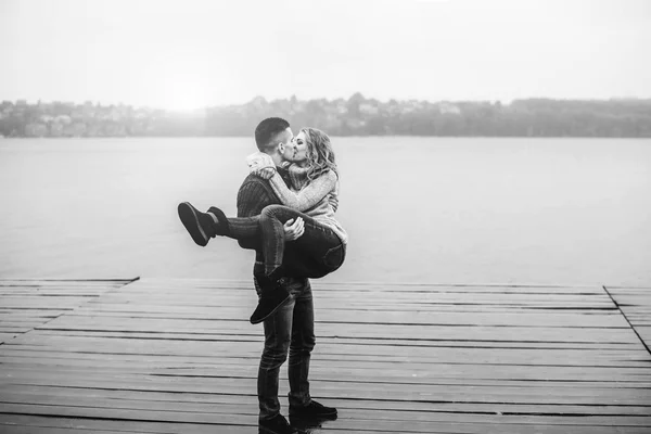 Young boy holding his girl in arms — Stockfoto