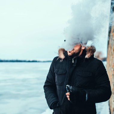 Adam elektronik sigara içiyor.