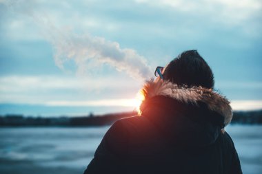 Adam elektronik sigara içiyor.