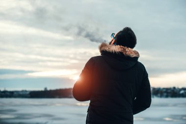 Adam elektronik sigara içiyor.