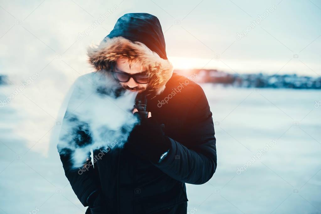 Man smokes  electronic cigarette