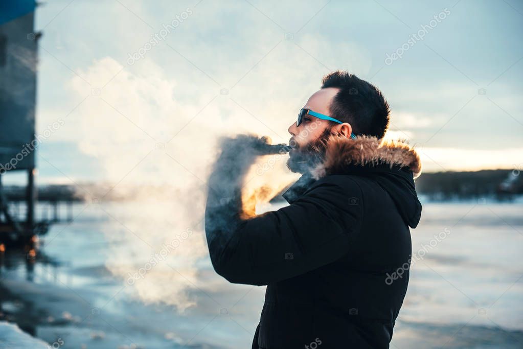 Man smokes  electronic cigarette
