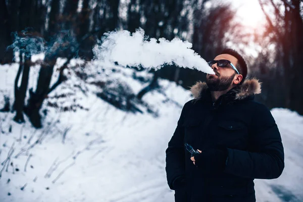 Man with beard smoking  electronic cigarette — Stock Photo, Image