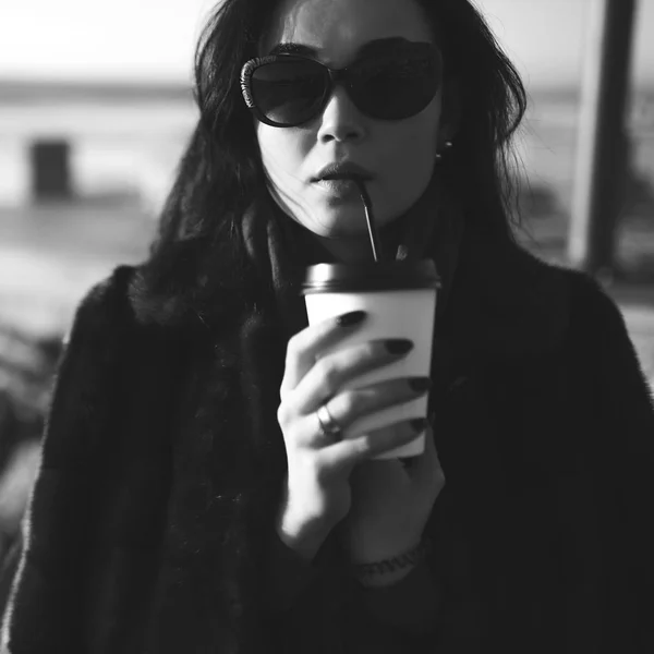 Brunette meisje lopen buiten in het park met kopje koffie — Stockfoto