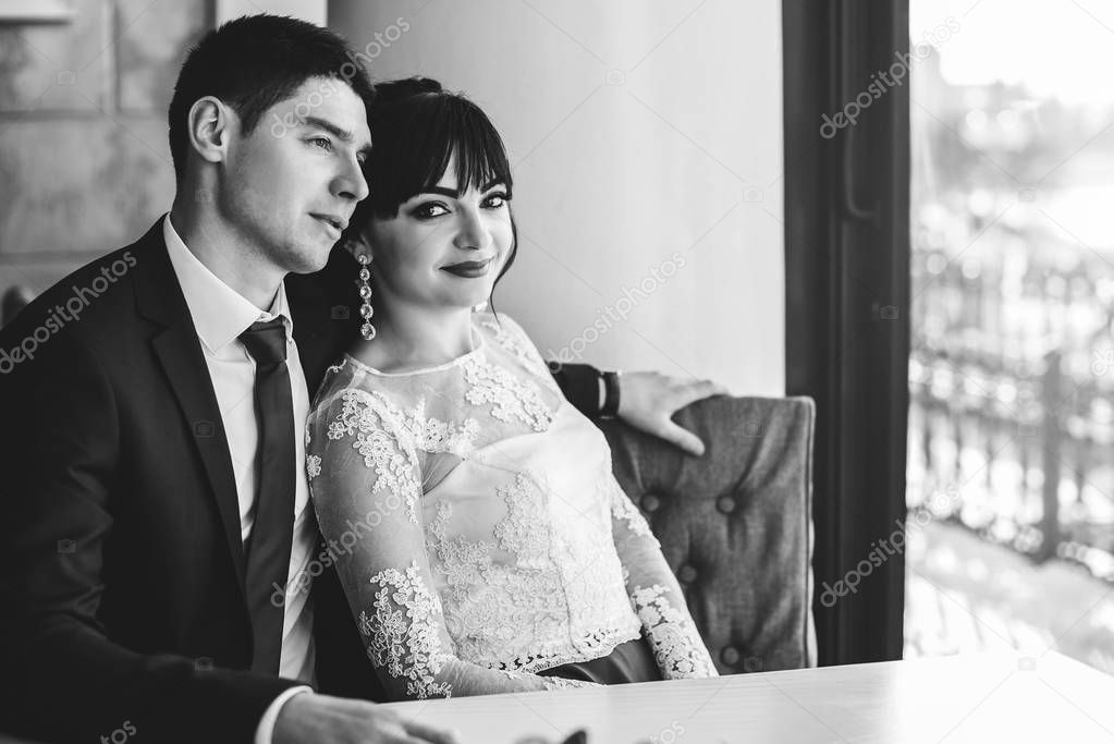 wedding couple relaxing in cafe