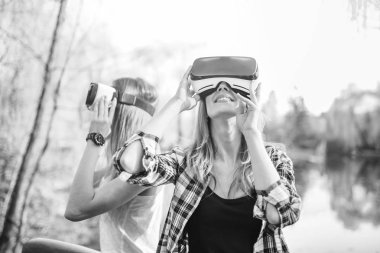 girls enjoy virtual reality glasses clipart
