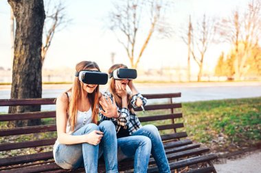 Kızlar sanal gerçeklik gözlükleri tadını çıkarın. 