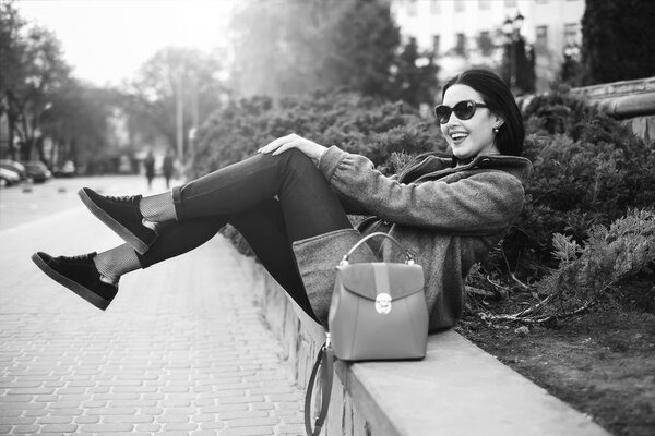 girl sitting outdoor with backpack