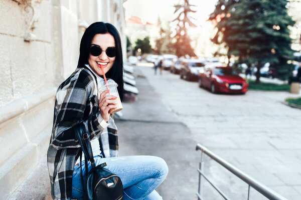 brunette girl enjoy cold coffee