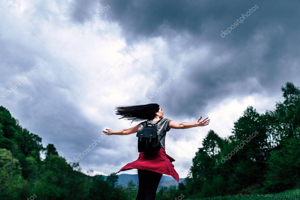 Woman with cloudy sky