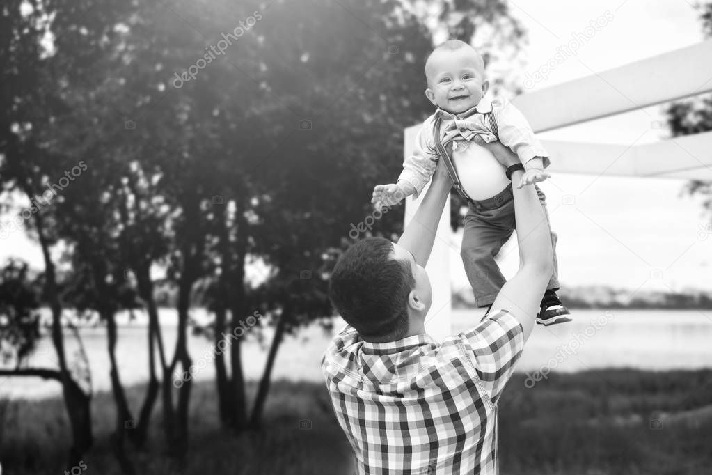 Happy young father with little son have fun outdoor in the park