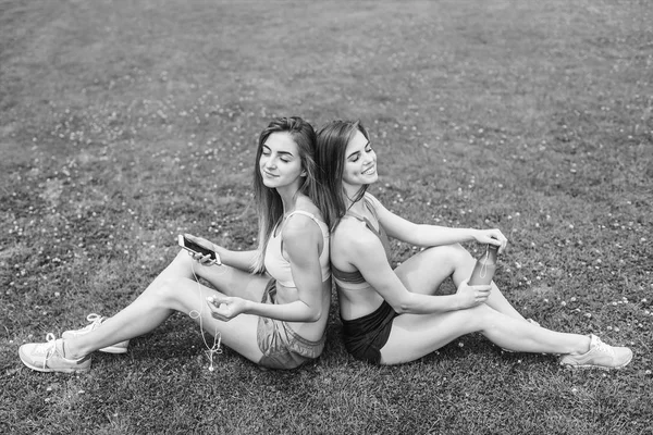 Duas mulheres esportivas relaxando após o treino — Fotografia de Stock