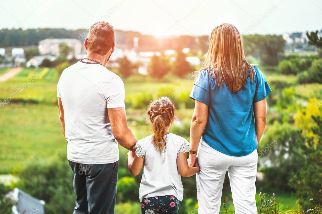 family with little daughter outdoors