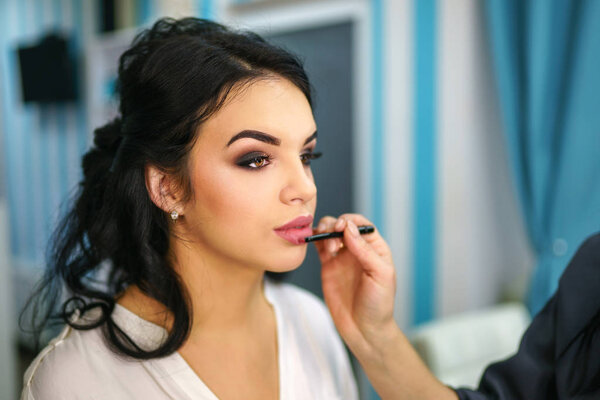 Beautiful bride on the makeup before wedding ceremony