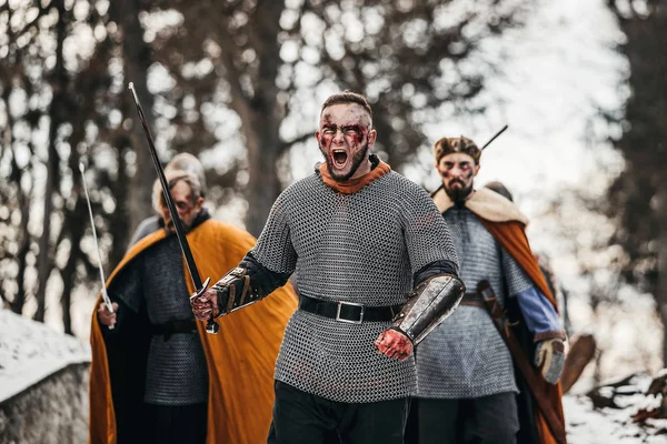 Photo of knights in armor with swords during the war. Evil emotions of a warrior who goes to battle with the sword — Stock Photo, Image