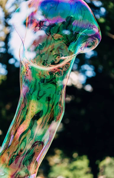 A giant bubble soap full of colors floating freely in the air