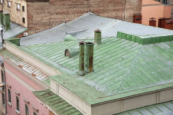 Old iron roof of a house covered with green paint
