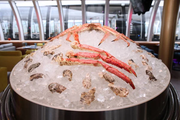 Kamchatka crab on ice in the restaurant, serving the table in th