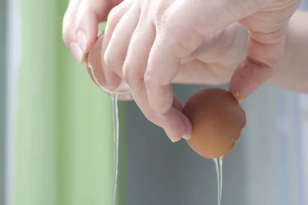 Bereiding van biscuit rollen. Stadia van voorbereiding. Het toevoegen van ingrediënten. Een vrouw voegt een ei. — Stockfoto