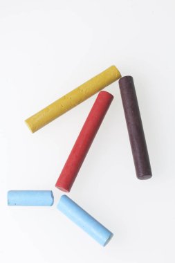 Farklı renklerde boya kalemi pastel. Bir kutu içinde onların yerleri, yalan. Bir ok şeklinde. Beyaz bir arka plan üzerinde. Karede çapraz olarak.