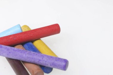 Farklı renklerde boya kalemi pastel. Bir kutu içinde onların yerleri, yalan. Beyaz bir arka plan üzerinde. Kaotik bir düzen içinde.