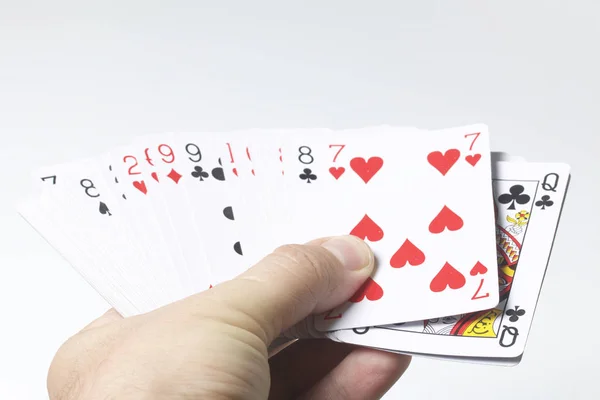 Card game. The man holds out a pack of cards. On a white background. Stock Photo