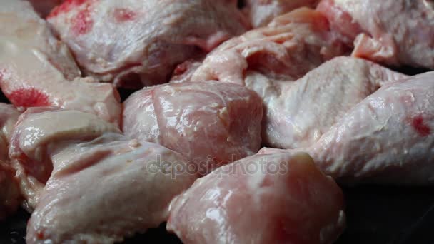 The man lays sprigs of rosemary on chicken pieces. Meat, marinated in mayonnaise, is laid out on a baking tray. — Stock Video