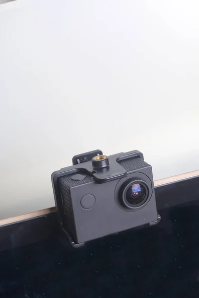 The action camera is fixed on the tablet. On a white background.