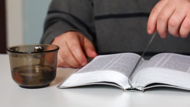 Ένας Άνθρωπος Διαβάζει Την Αγία Γραφή Κάνει Ένα Σελιδοδείκτη Και — Αρχείο Βίντεο