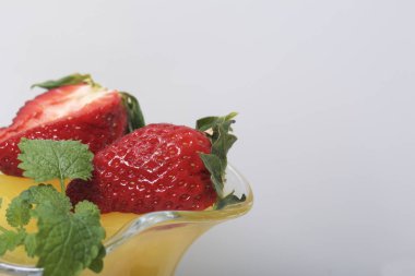 Çilek ve nane ile dekore edilmiş çanak çömlek, jöle.