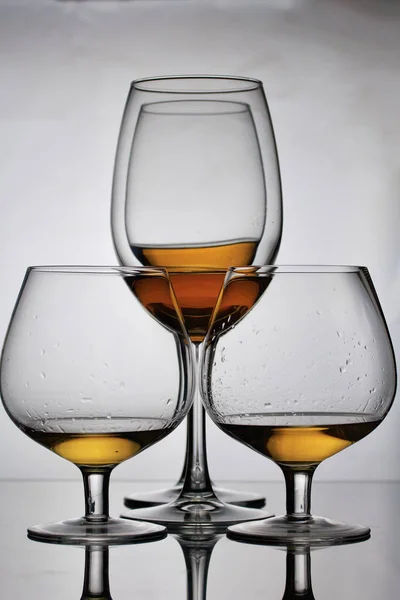 Bicchieri di vino su gambe lunghe. Nelle vicinanze ci sono bicchieri su una gamba corta. Hanno una piccola quantità di alcol . — Foto Stock